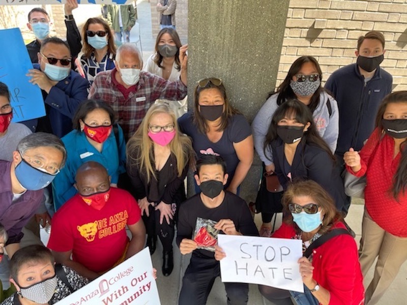 large group with signs against racism