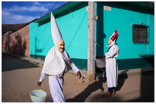 photo of man in white robe and face mask