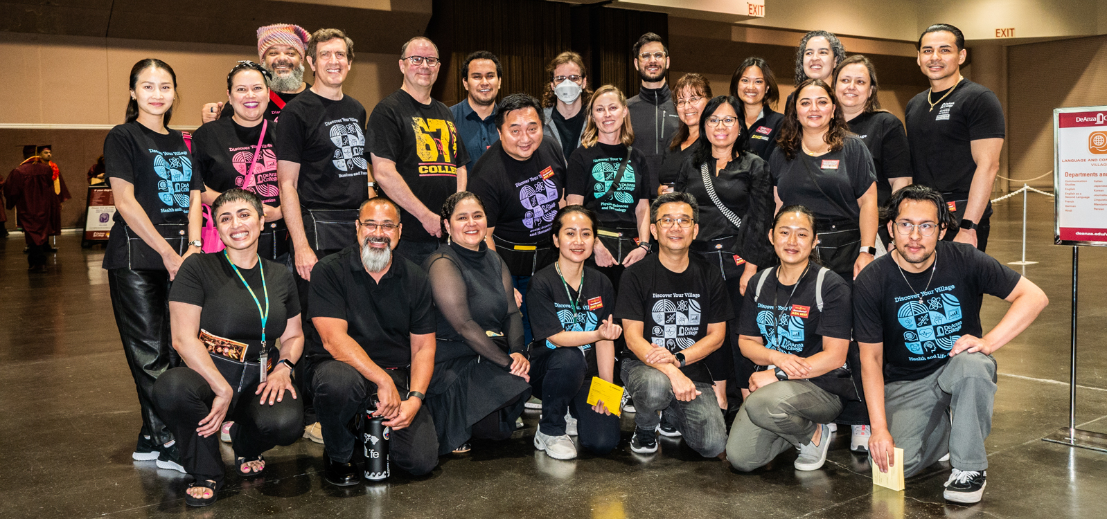 large group of classified staff working at graduation