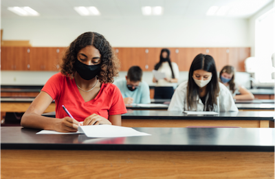 students seated with masks 