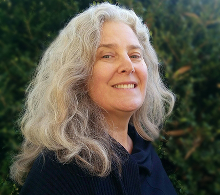 Cynthia Kaufman: smiling woman with long hair and black blouse