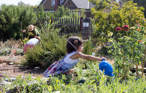 young girl with watering can